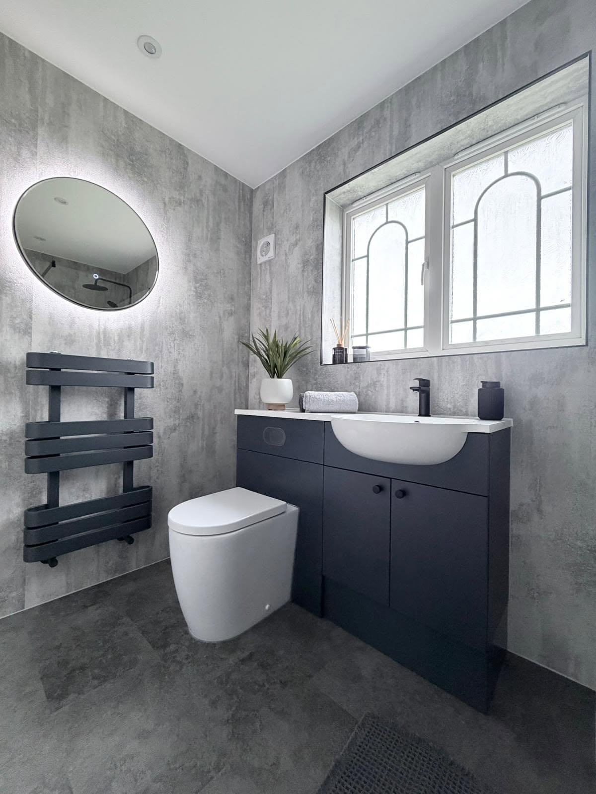 Large-format modern bathroom surfaces with minimal grout lines and contemporary detailing