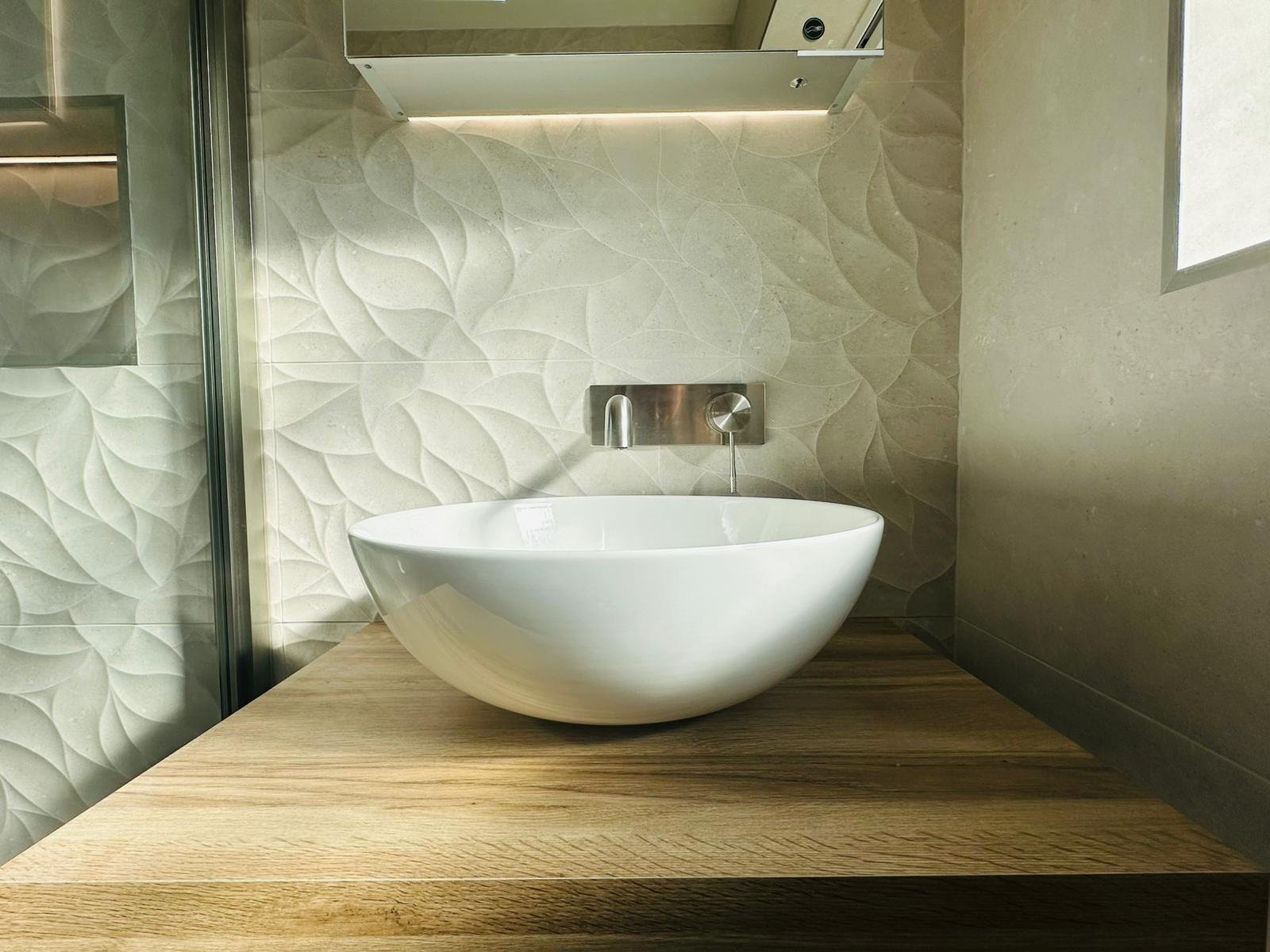 Water-efficient basin and tap arrangement in a botanical Derbyshire bathroom